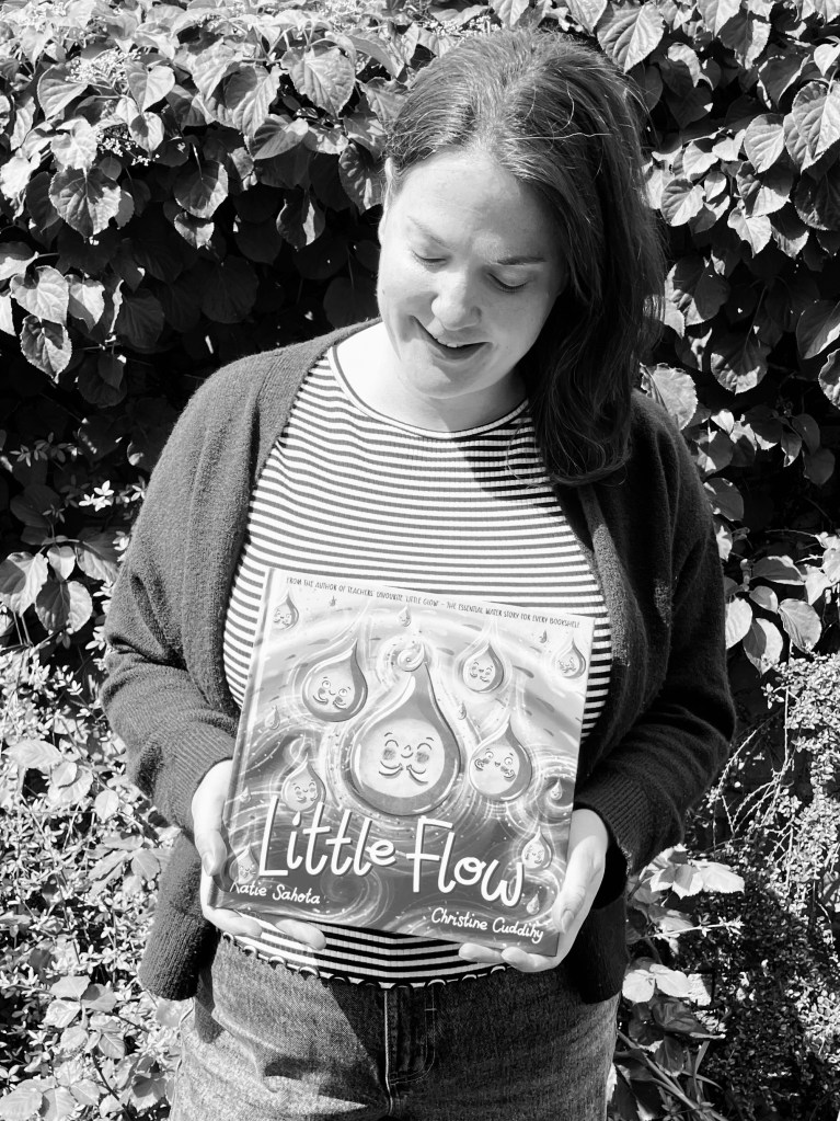 Image of Christine Cuddihy holding a book called Little Flow